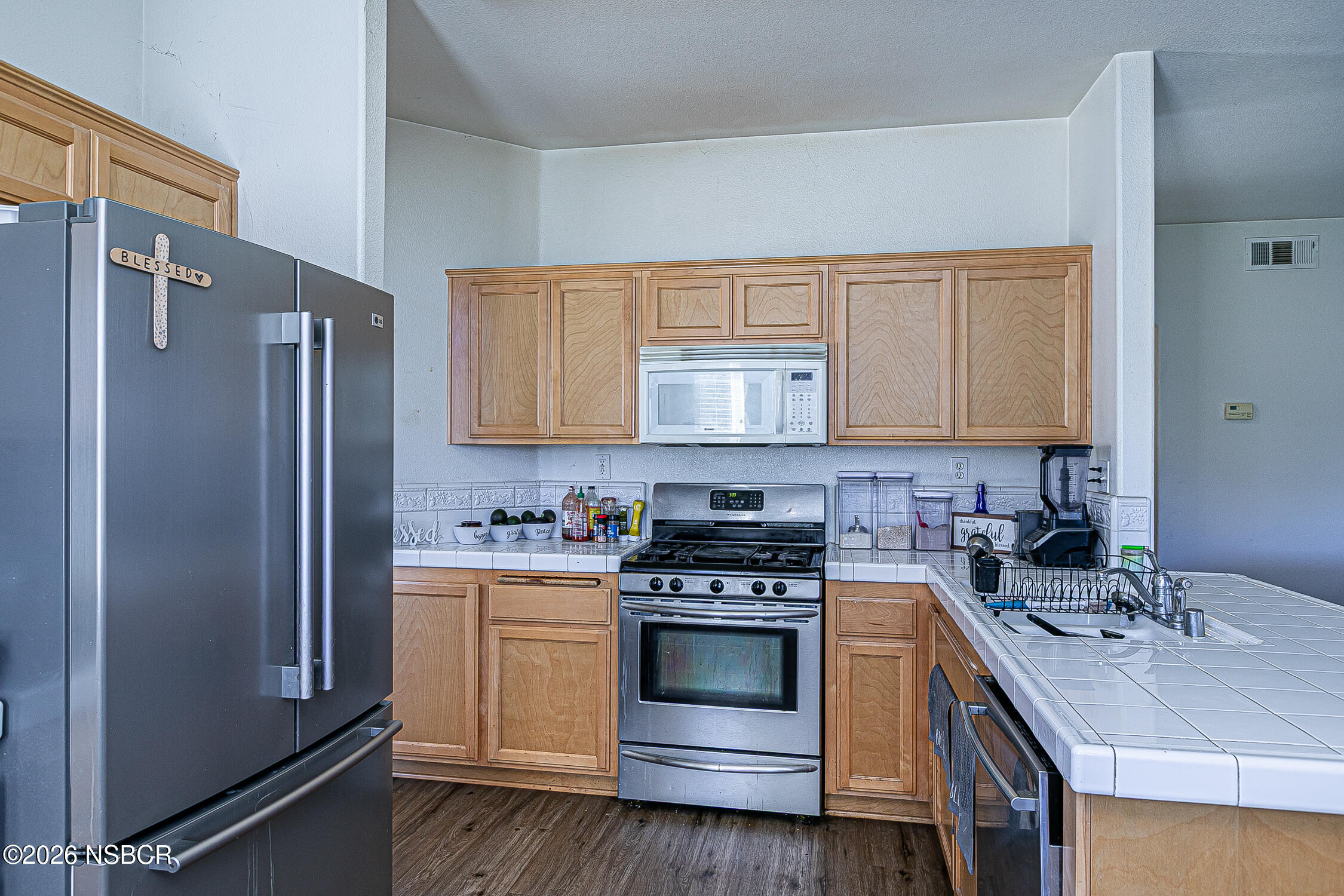 1838 Gable Lane Santa Maria, CA 93458 - Photo 12 of 31 a kitchen with a stove sink and refrigerator