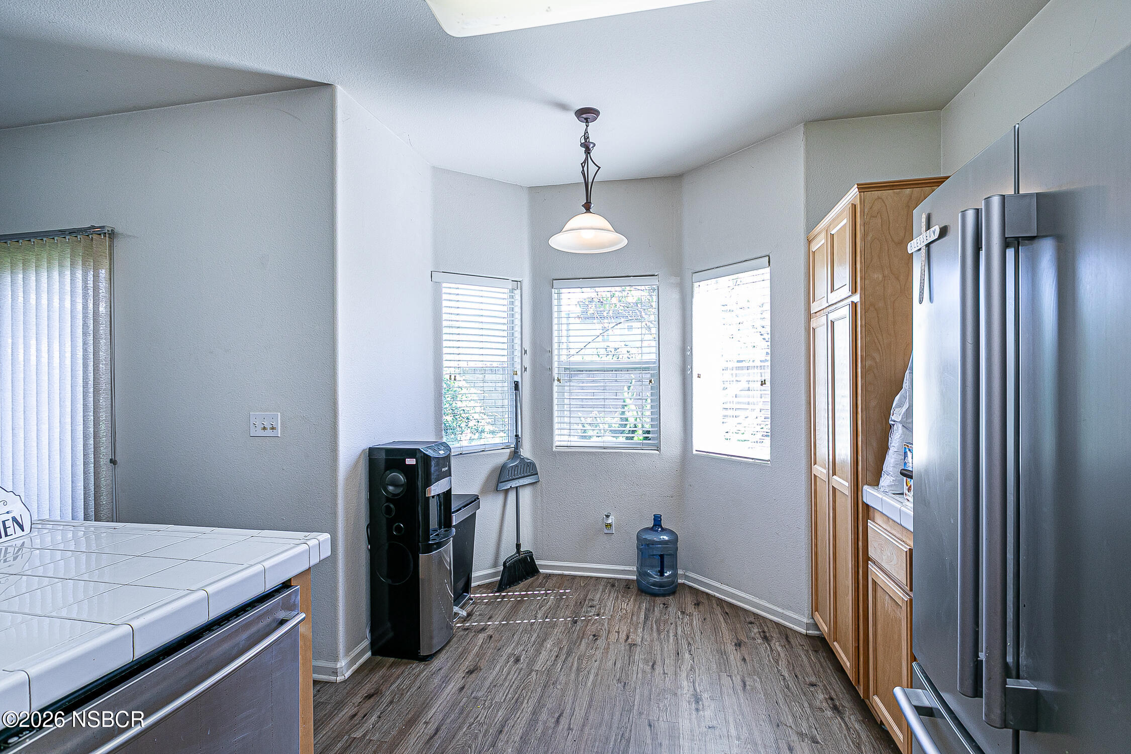 1838 Gable Lane Santa Maria, CA 93458 - Photo 14 of 31 a kitchen that has a lot of furniture and wooden floor