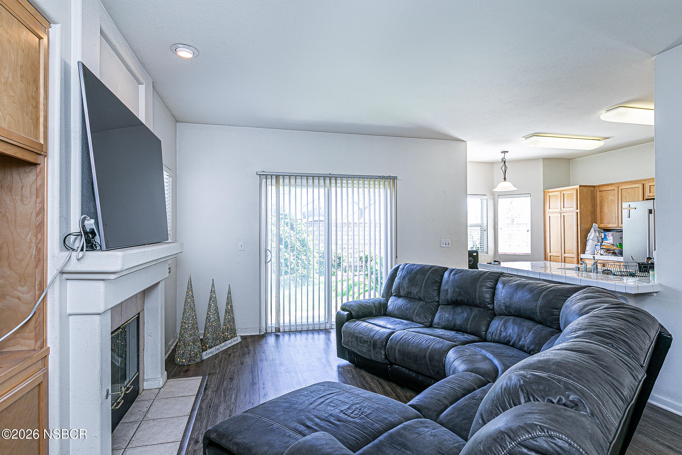 1838 Gable Lane Santa Maria, CA 93458 - Photo 9 of 31 a living room with furniture a fireplace and a flat screen tv