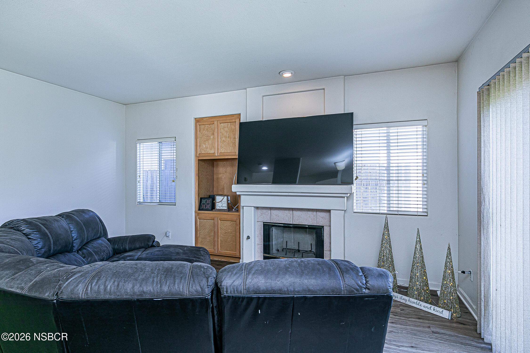 1838 Gable Lane Santa Maria, CA 93458 - Photo 10 of 31 a living room with furniture a flat screen tv and a fireplace