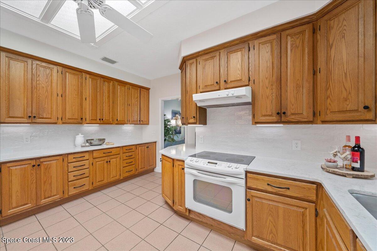 4150 Windover Way Melbourne, FL 32934 - Photo 15 of 57 a kitchen with stainless steel appliances granite countertop wooden cabinets a sink and dishwasher