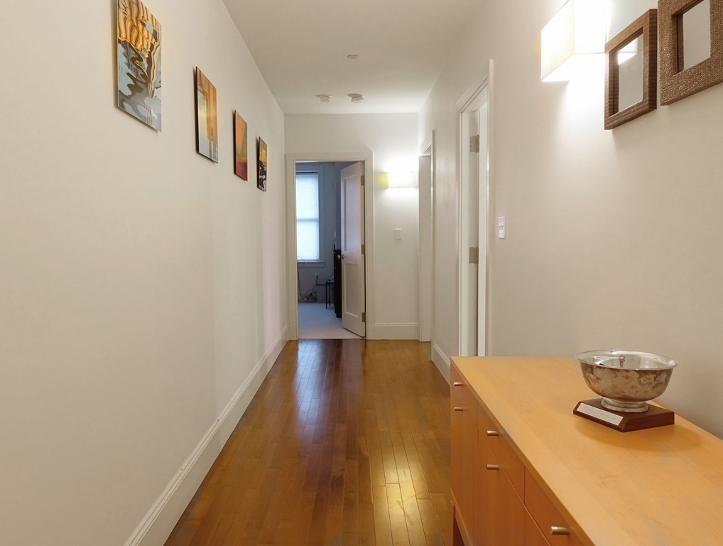 116 Rantoul Street, Unit 210 Beverly, MA 01915 - Photo 12 of 16 a bedroom with a bed and a potted plant