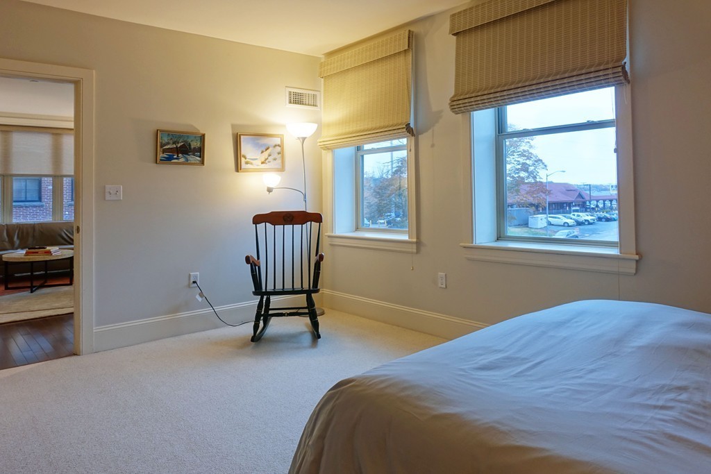 116 Rantoul Street, Unit 210 Beverly, MA 01915 - Photo 13 of 16 a bedroom with a bed and a window