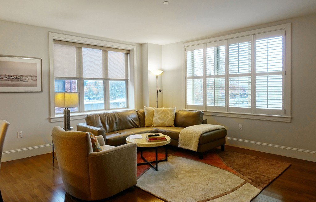 116 Rantoul Street, Unit 210 Beverly, MA 01915 - Photo 3 of 16 a living room with furniture and a large window