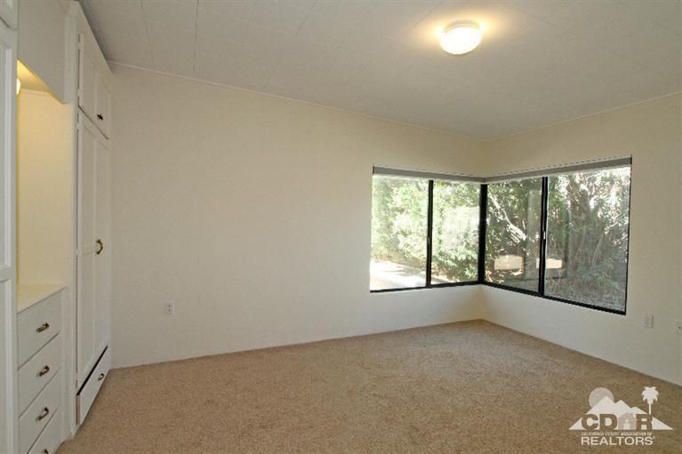 71523 Sahara Road Rancho Mirage, CA 92270 - Photo 13 of 30 an empty room with windows and yard