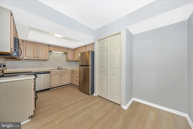 a kitchen with a sink cabinets and wooden floor