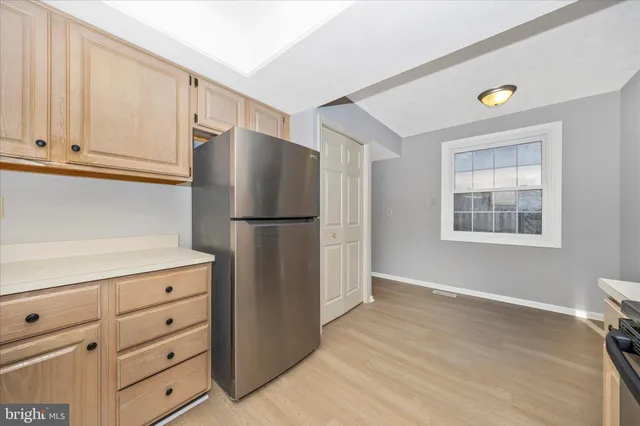 a kitchen with cabinets appliances and a window