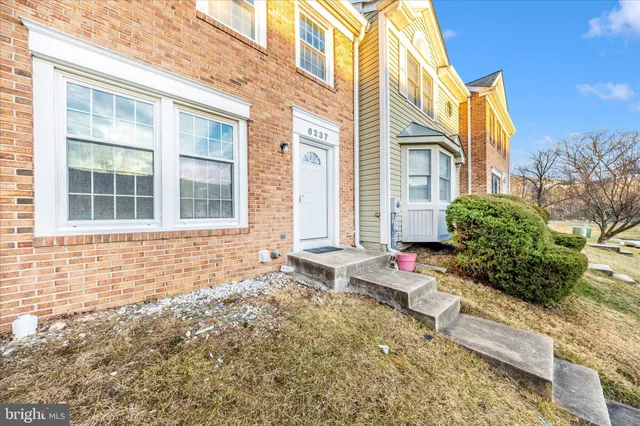 a view of a backyard with wooden fence