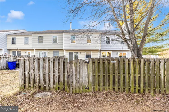 a view of a house with a wooden fence