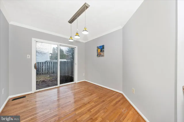 a view of room with window and wooden floor