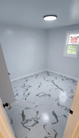 a view of an empty room and a window