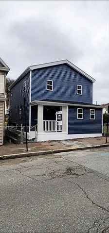 a front view of a building with a garden