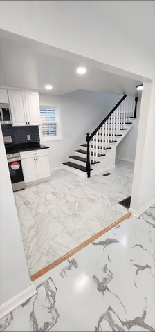a view of kitchen with stainless steel appliances kitchen island sink refrigerator and stove
