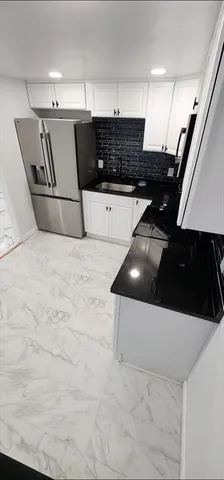 a kitchen with a sink and a stove top oven