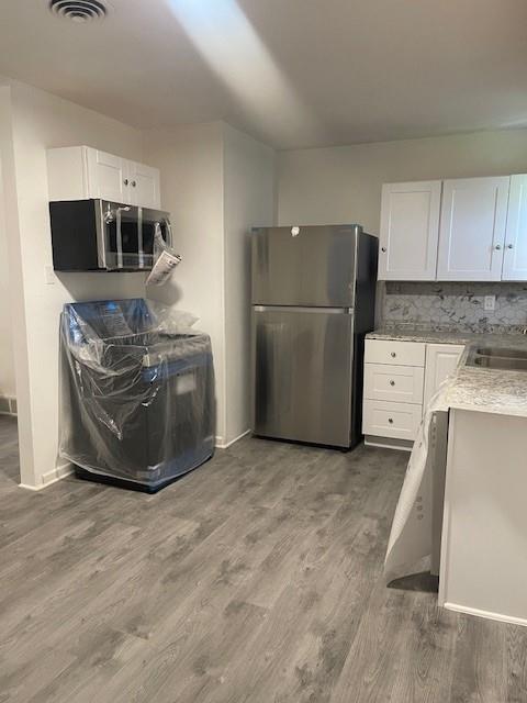 12435 Oberlin Drive Dallas, TX 75243 - Photo 15 of 19 a kitchen with stainless steel appliances granite countertop a refrigerator a stove a sink and a microwave