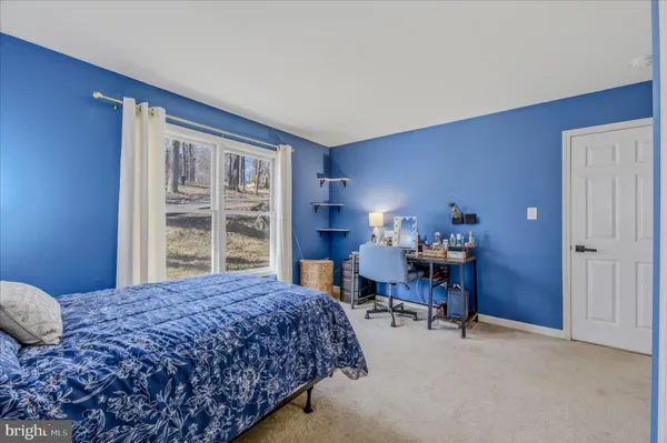 a bedroom with a bed lamp and window