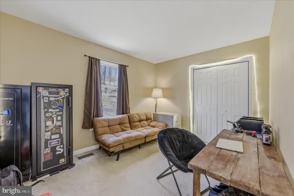 a room with pool table and windows
