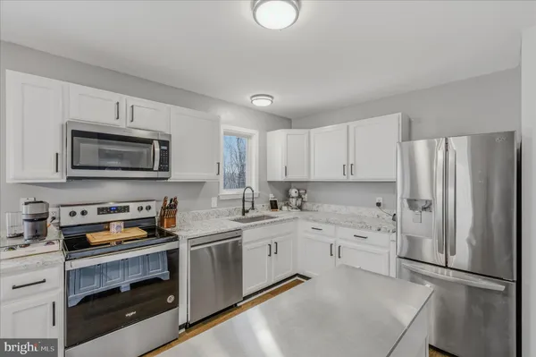 a kitchen with a sink a stove and refrigerator