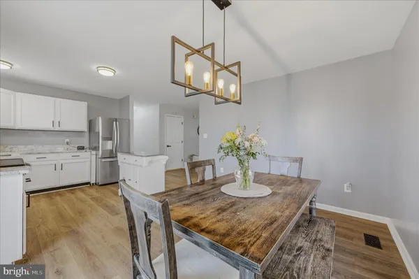 a kitchen with a table and chairs in it