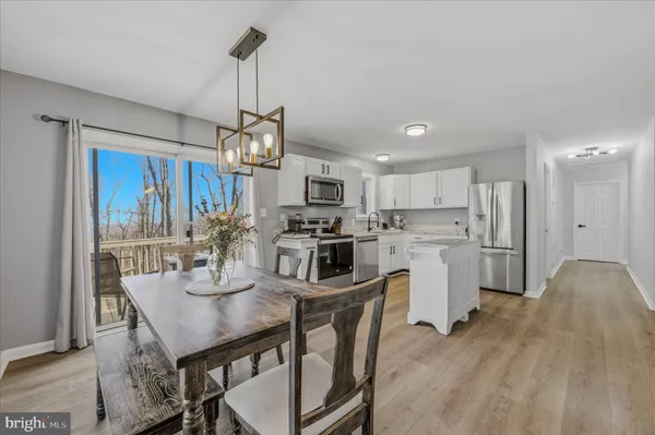 a kitchen with refrigerator cabinets dining table and chairs