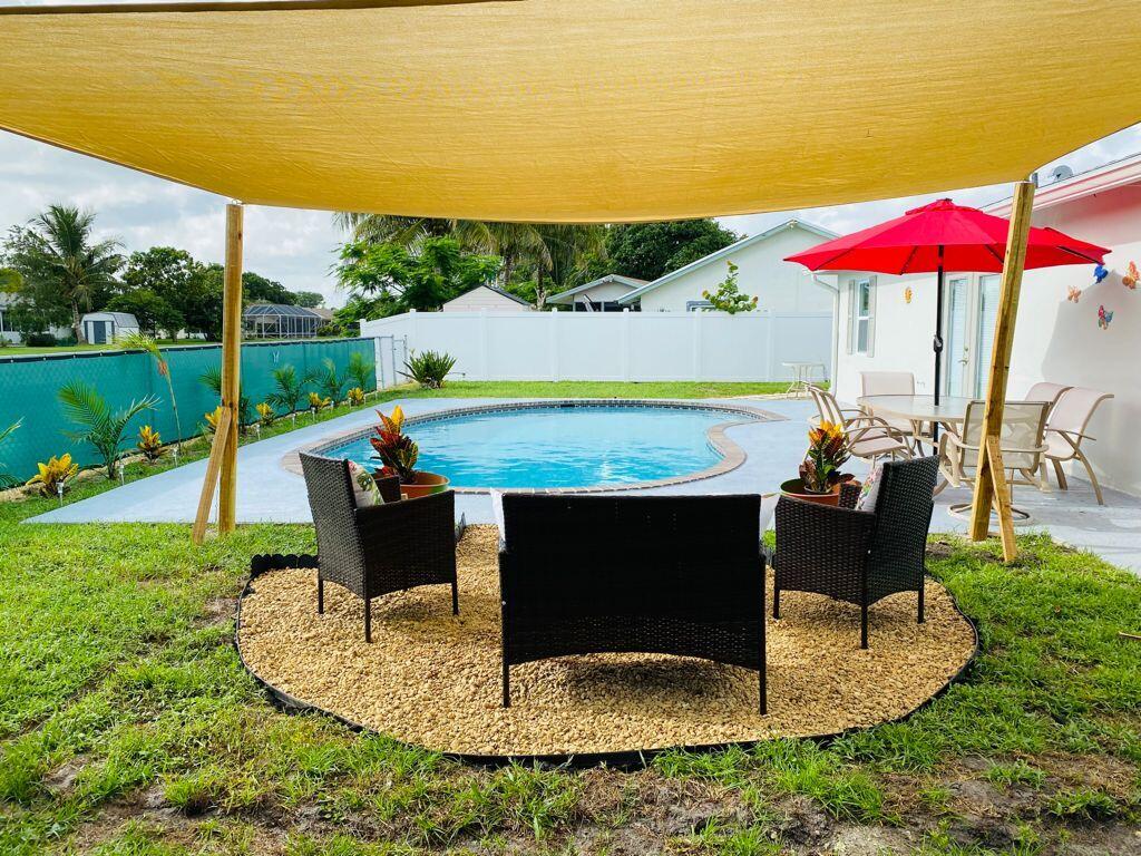9793 Alaska Circle Boca Raton, FL 33434 - Photo 7 of 10 Boca Pool sitting area from behind
