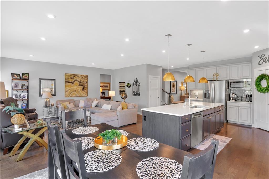 205 Regency Drive Eighty Four, PA 15330 - Photo 12 of 43 a living room with furniture and a dining table with wooden floor