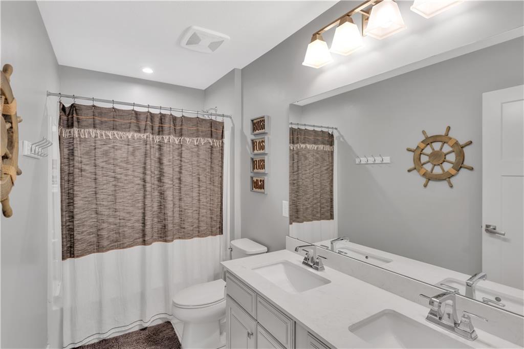 205 Regency Drive Eighty Four, PA 15330 - Photo 22 of 43 a bathroom with a sink a toilet and shower curtain