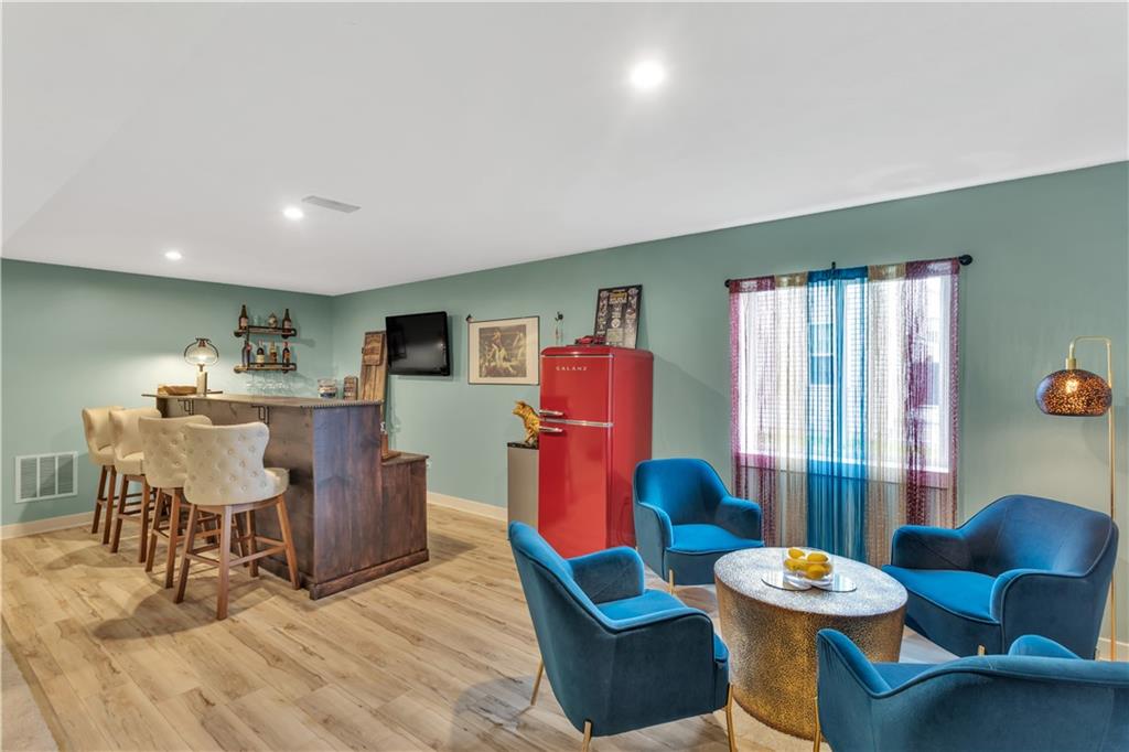 205 Regency Drive Eighty Four, PA 15330 - Photo 33 of 43 a living room with furniture a flat screen tv and a large window
