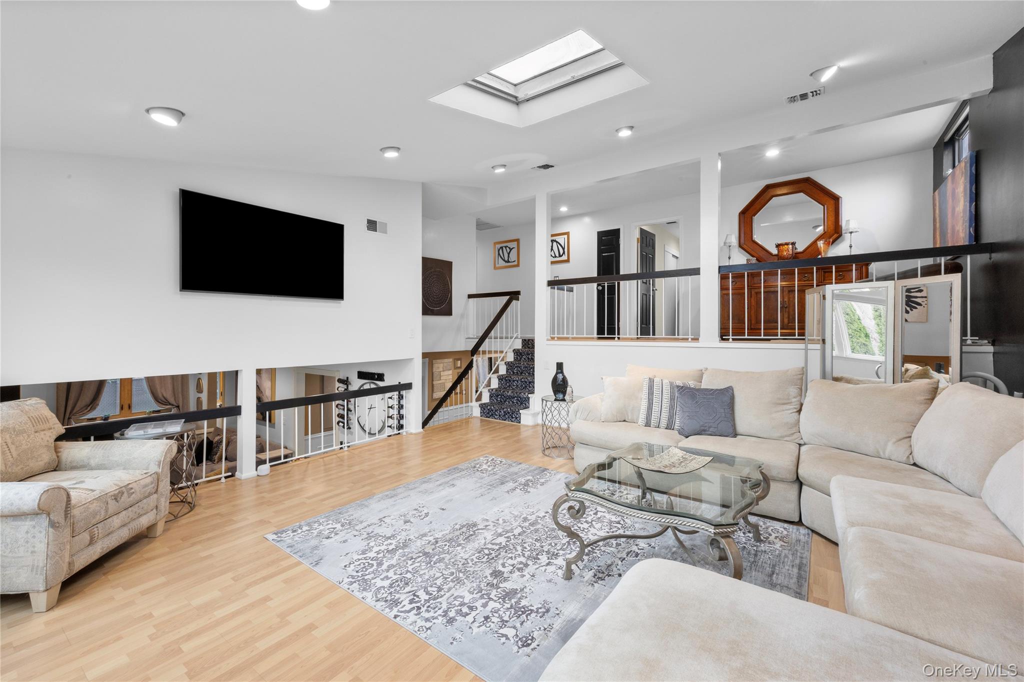 19 Jacob Road Plainview, NY 11803 - Photo 13 of 33 a living room with furniture and a flat screen tv