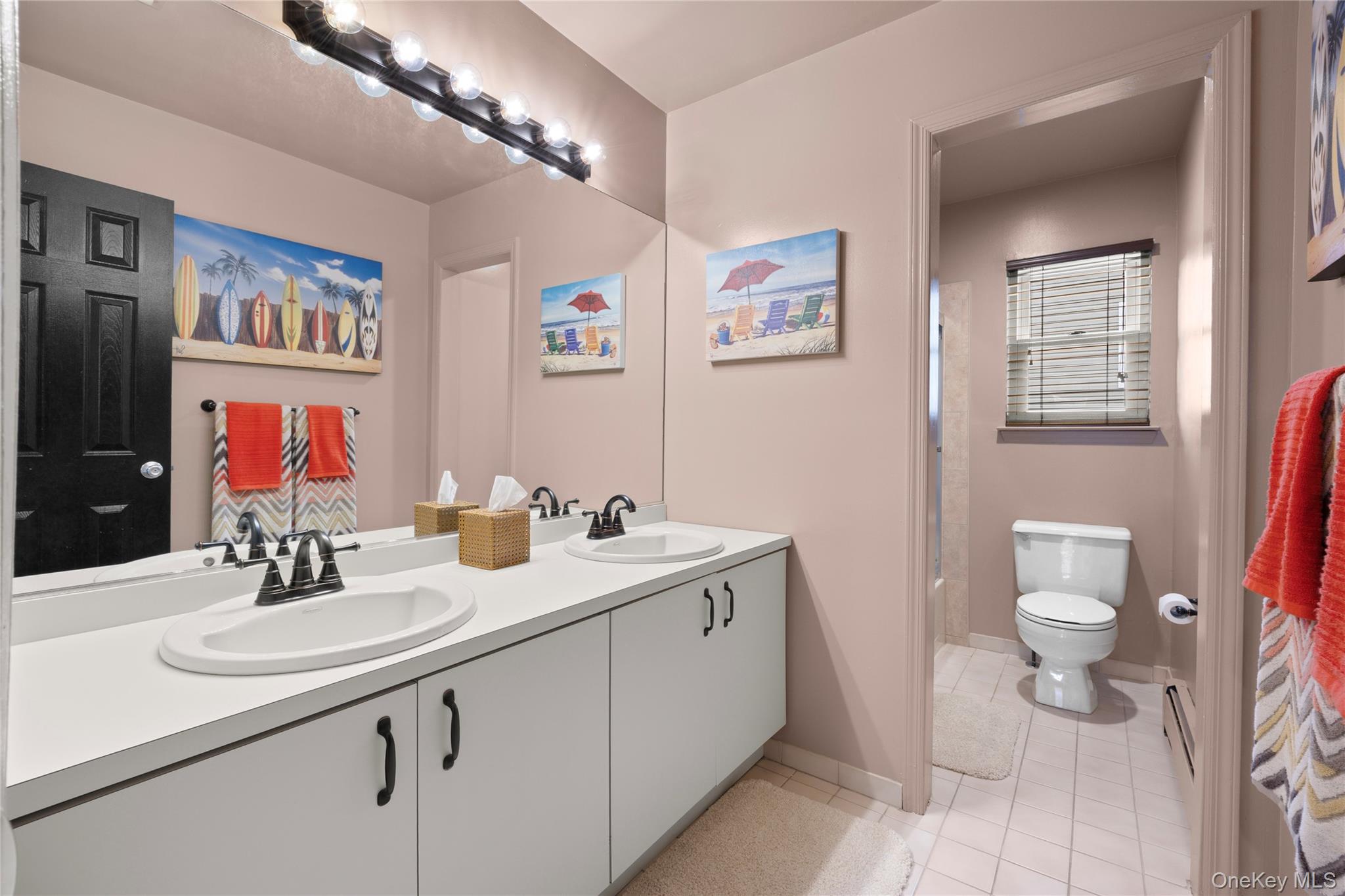 19 Jacob Road Plainview, NY 11803 - Photo 24 of 33 a bathroom with a sink double vanity and a toilet