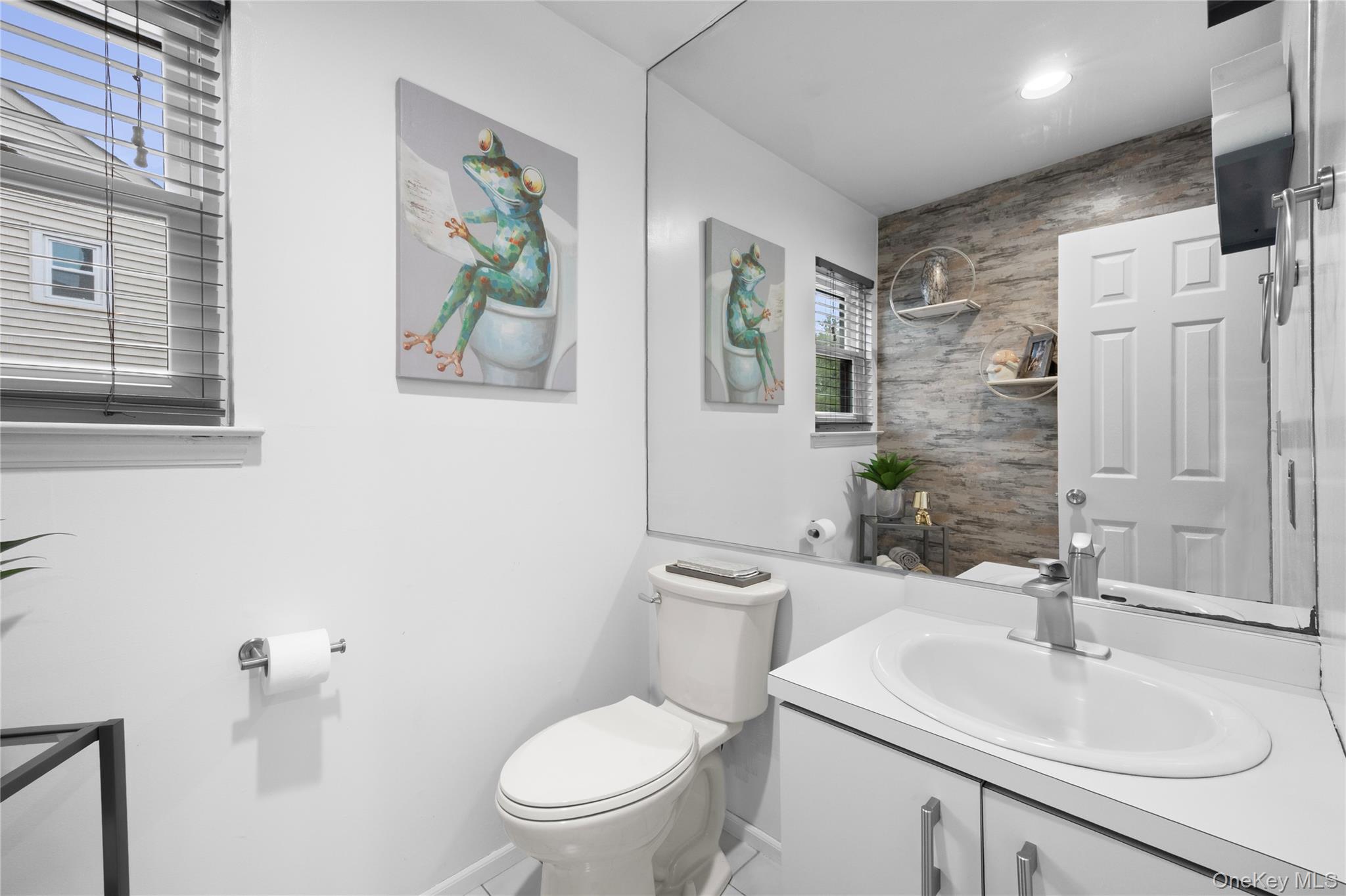 19 Jacob Road Plainview, NY 11803 - Photo 25 of 33 a bathroom with a toilet sink and mirror