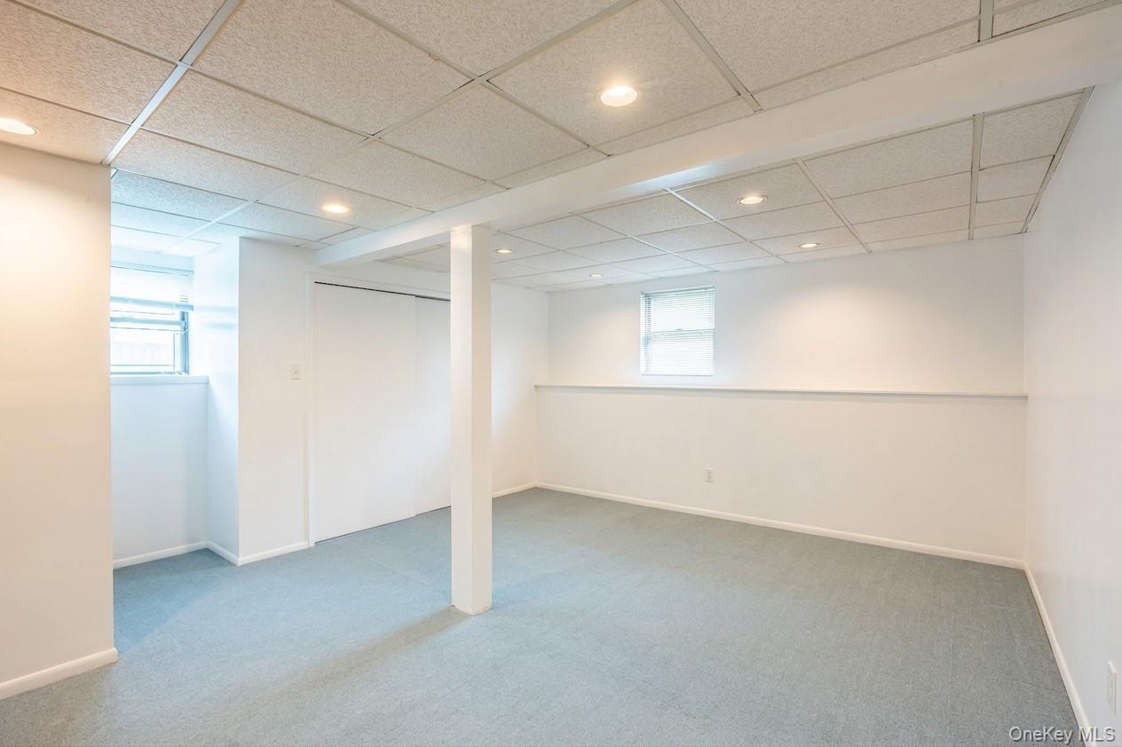 19 Jacob Road Plainview, NY 11803 - Photo 27 of 33 an empty room with a empty space and windows