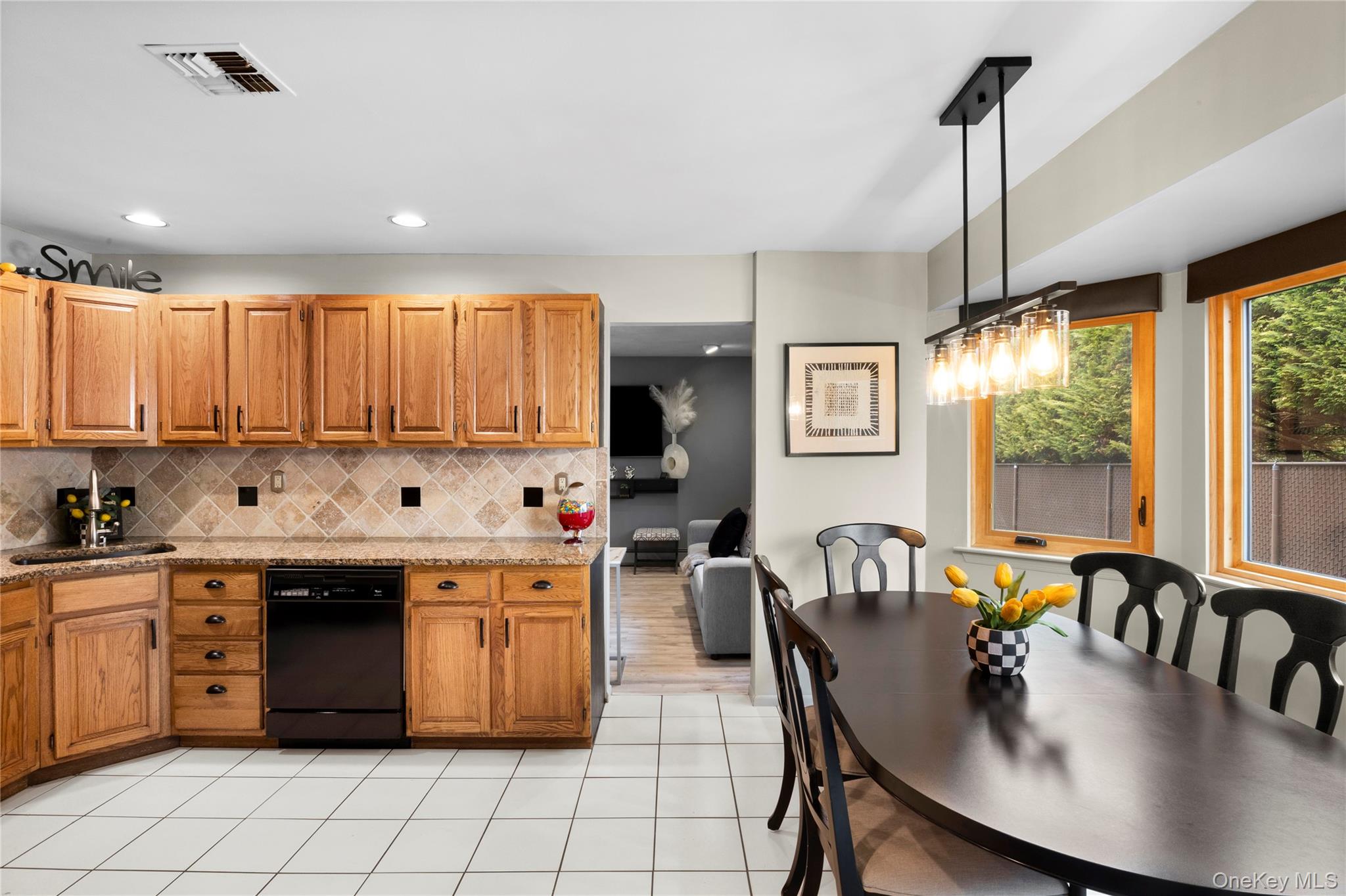 19 Jacob Road Plainview, NY 11803 - Photo 7 of 33 a kitchen with stainless steel appliances granite countertop a stove top oven a sink dishwasher and white cabinets with wooden floor