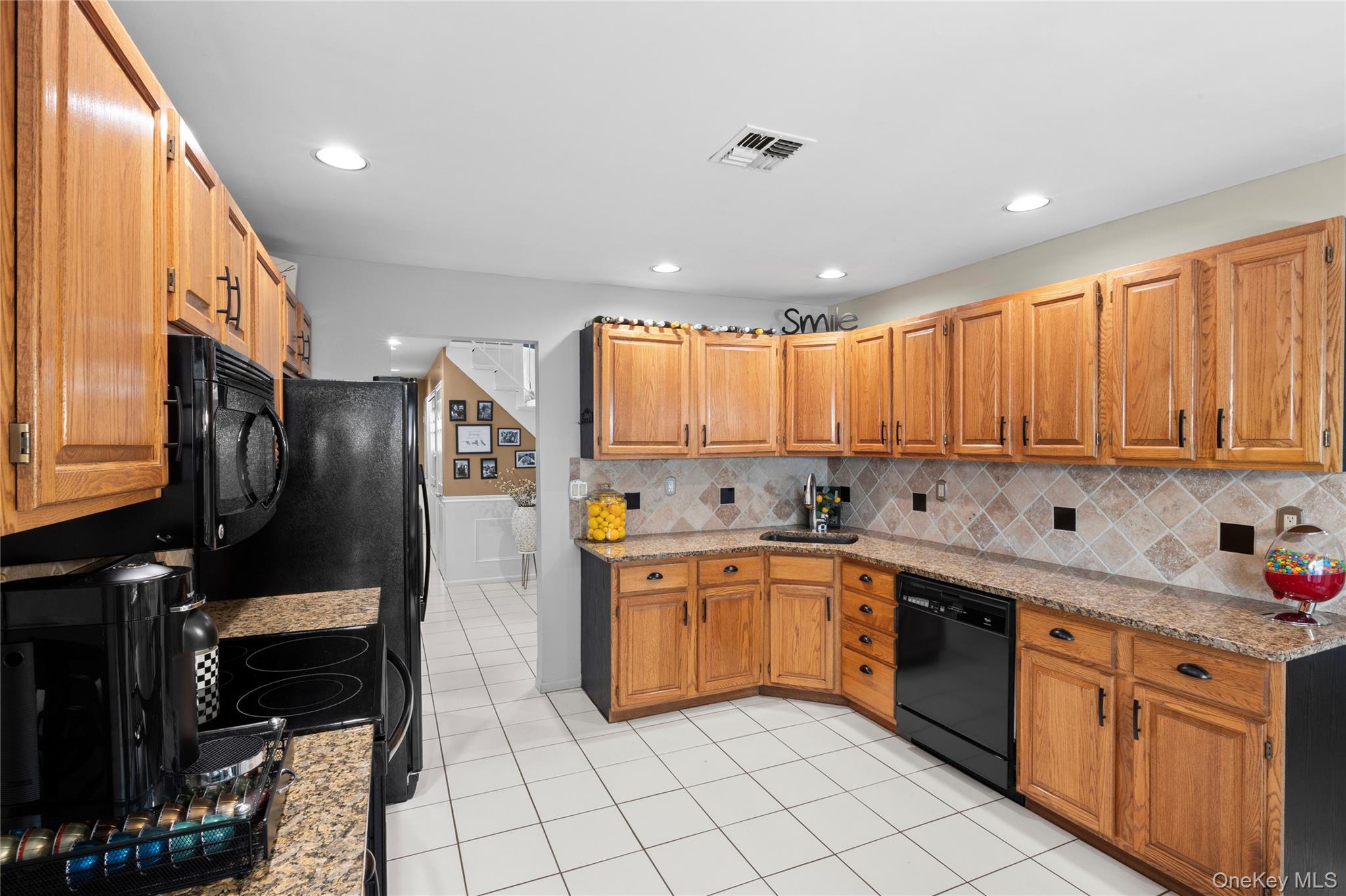 19 Jacob Road Plainview, NY 11803 - Photo 9 of 33 a large kitchen with stainless steel appliances granite countertop a sink and cabinets