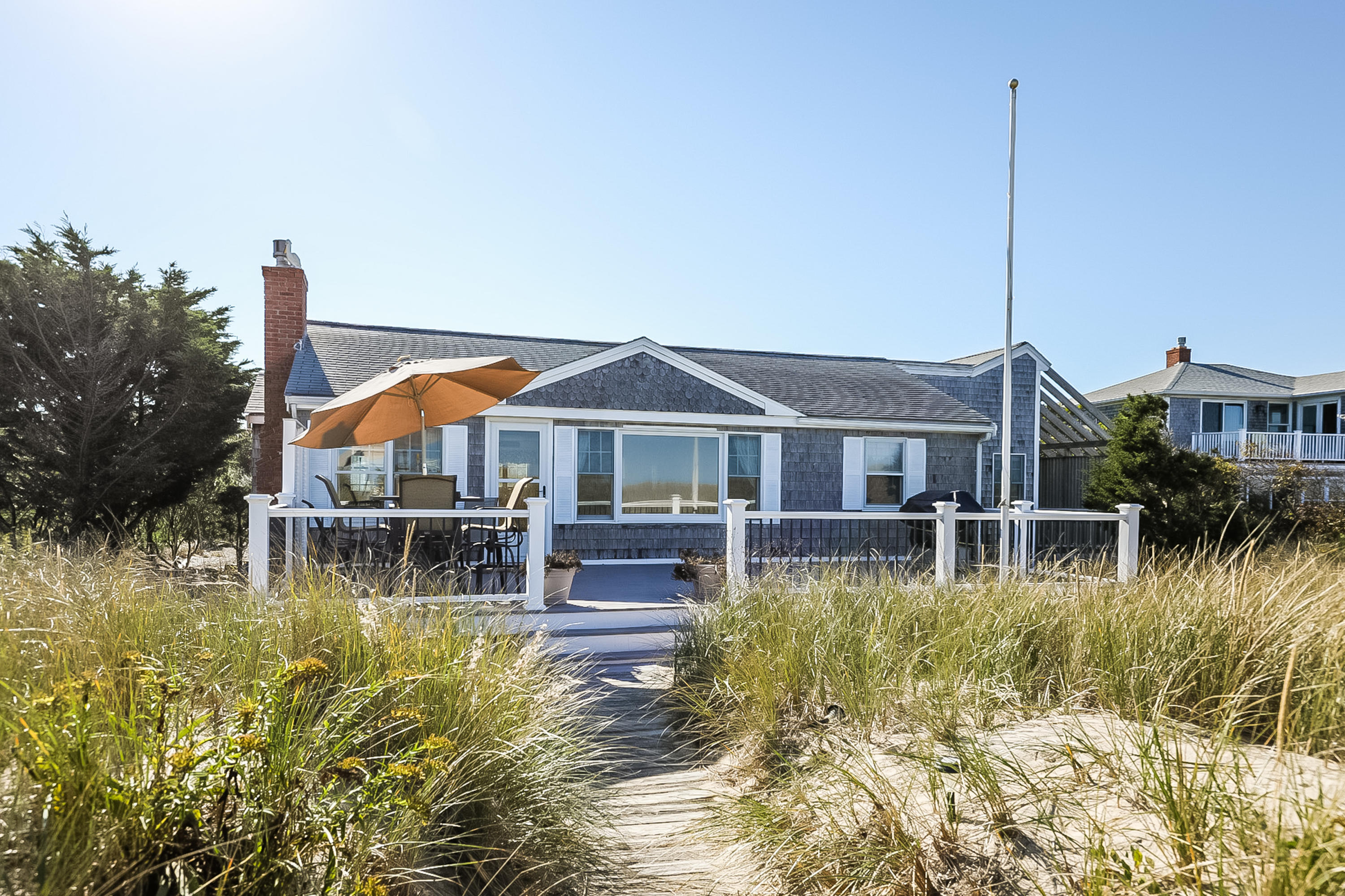 137 Phillips Road Sagamore Beach, MA 02562 - Photo 1 of 45 a front view of a house with swimming pool