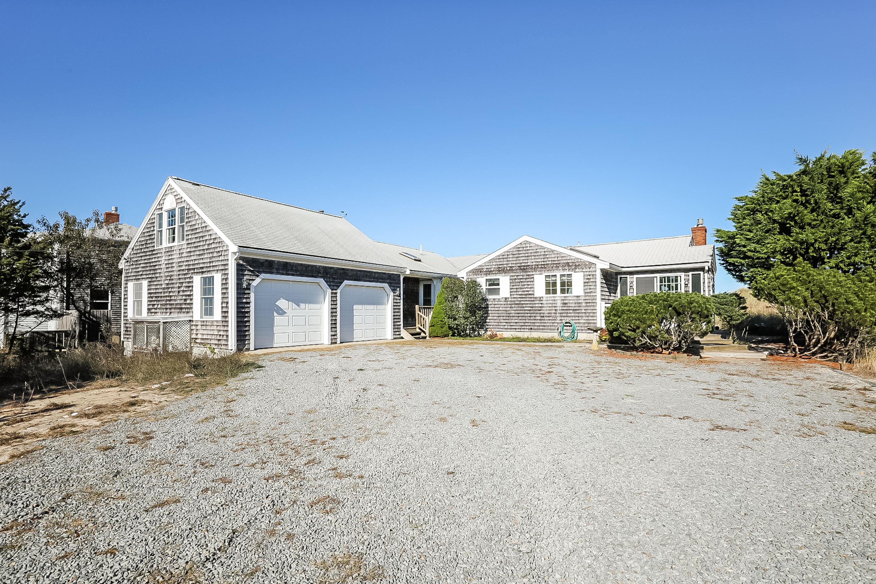137 Phillips Road Sagamore Beach, MA 02562 - Photo 4 of 45 a front view of a house with a yard and garage