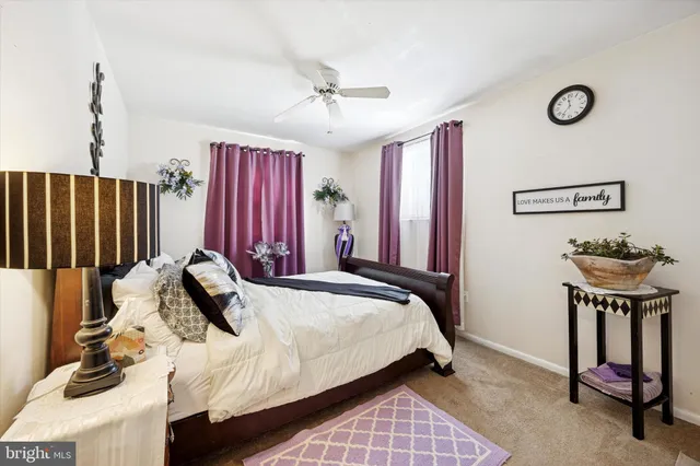 a bedroom with furniture and a flat screen tv