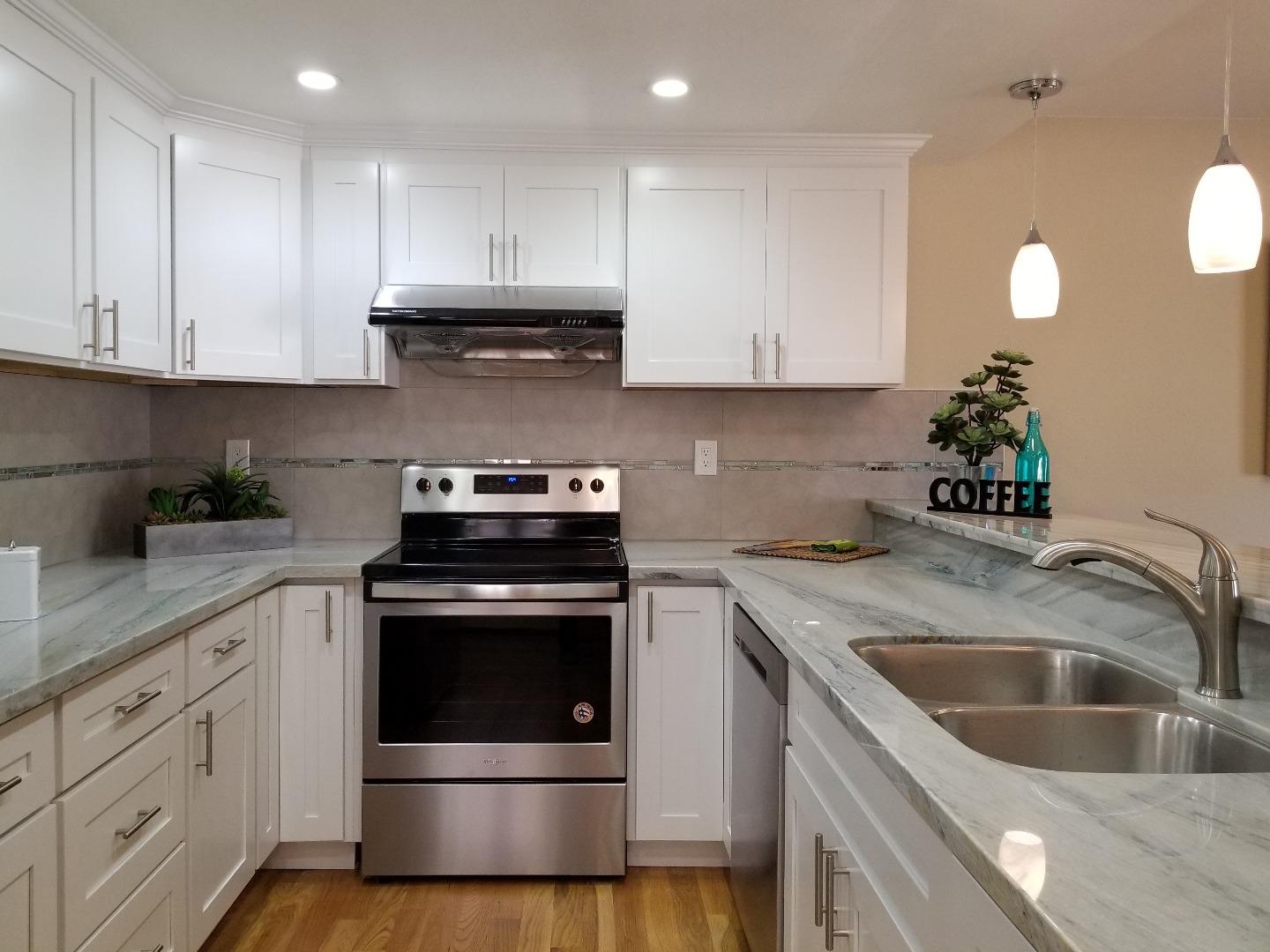 161 Redding Road Campbell, CA 95008 - Photo 8 of 21 a kitchen with granite countertop white cabinets and white appliances
