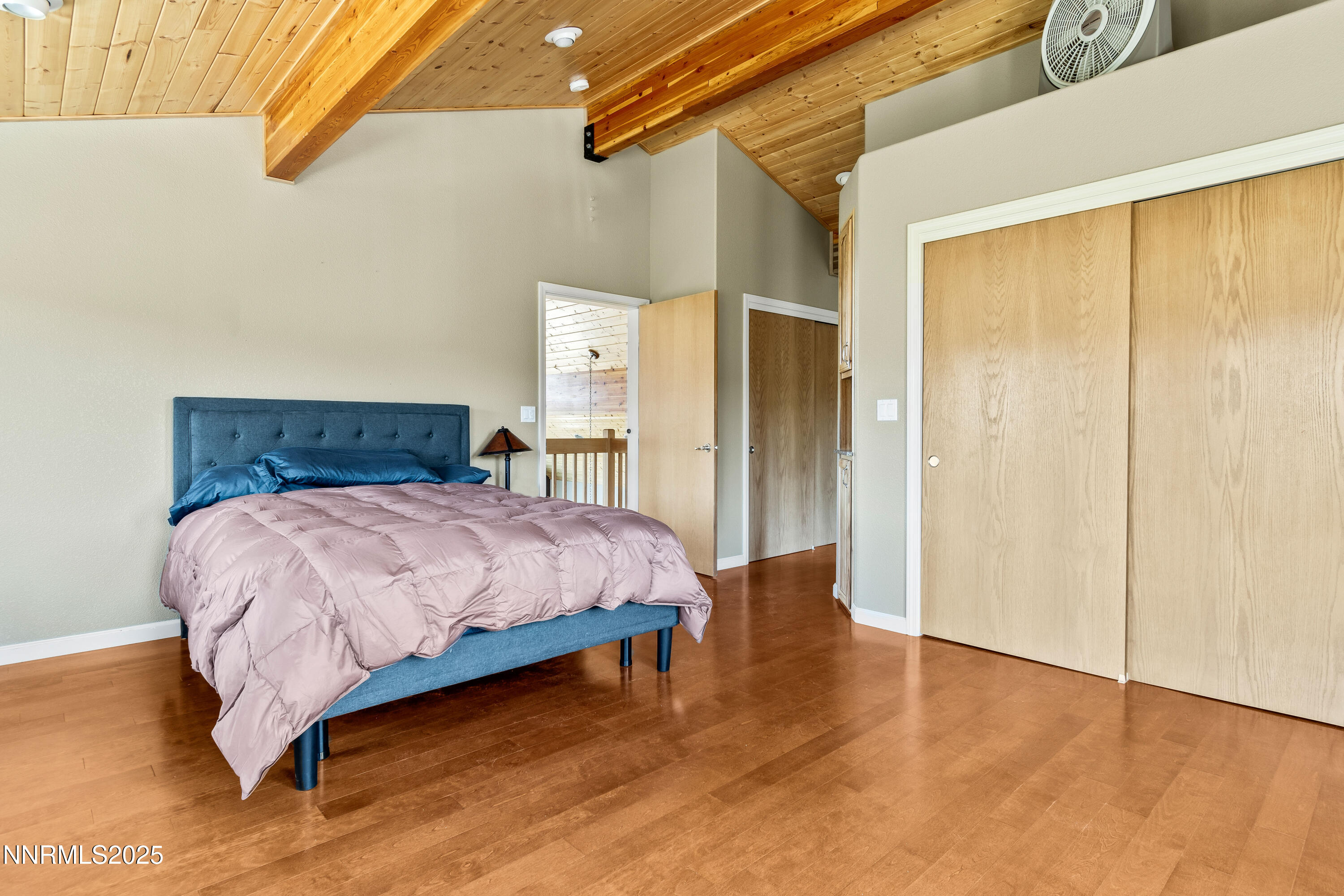 2140 Conestoga Road Reno, NV 89521 - Photo 11 of 35 a bedroom with a bed and wooden floor