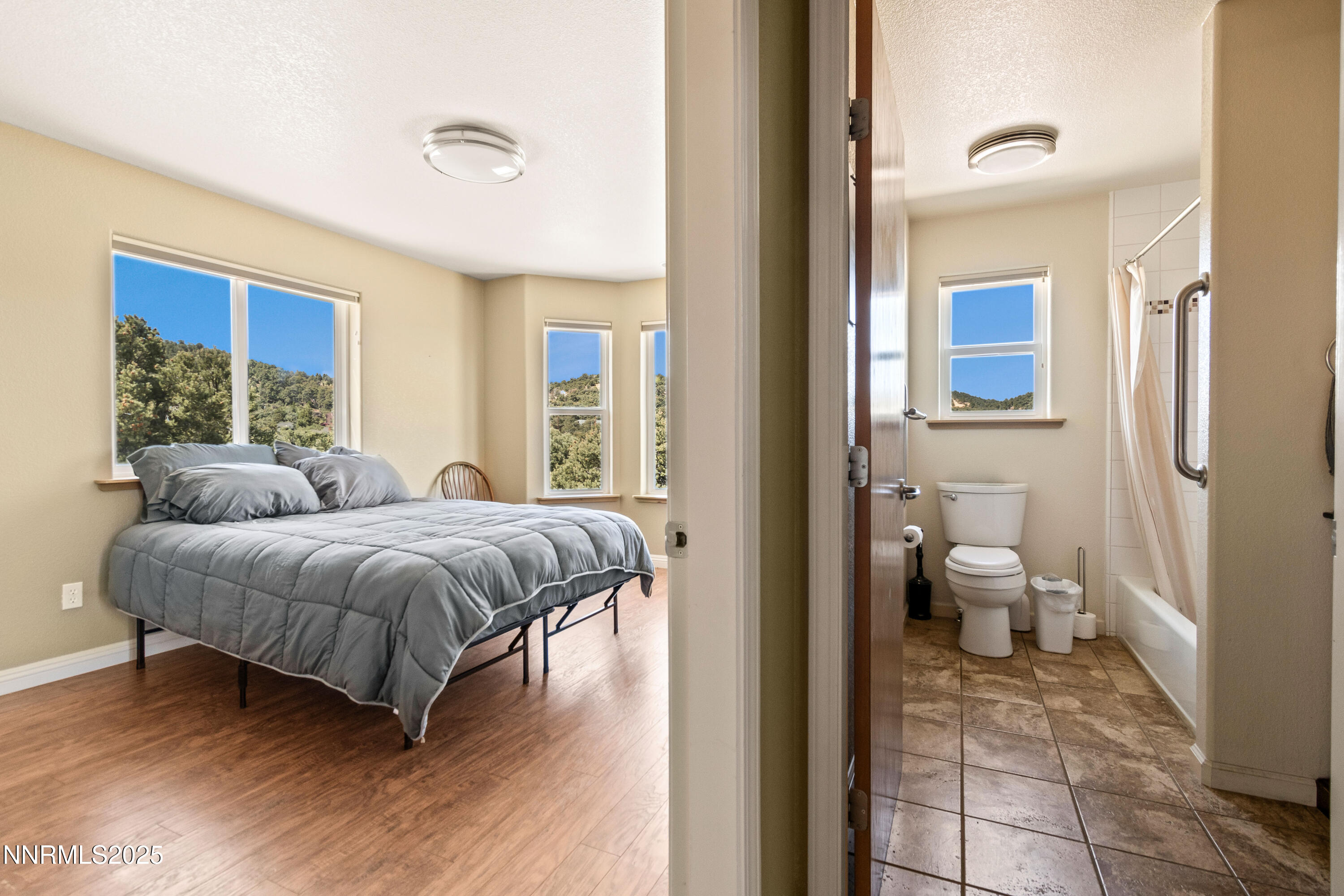 2140 Conestoga Road Reno, NV 89521 - Photo 19 of 35 a spacious bedroom with a bed and glass door