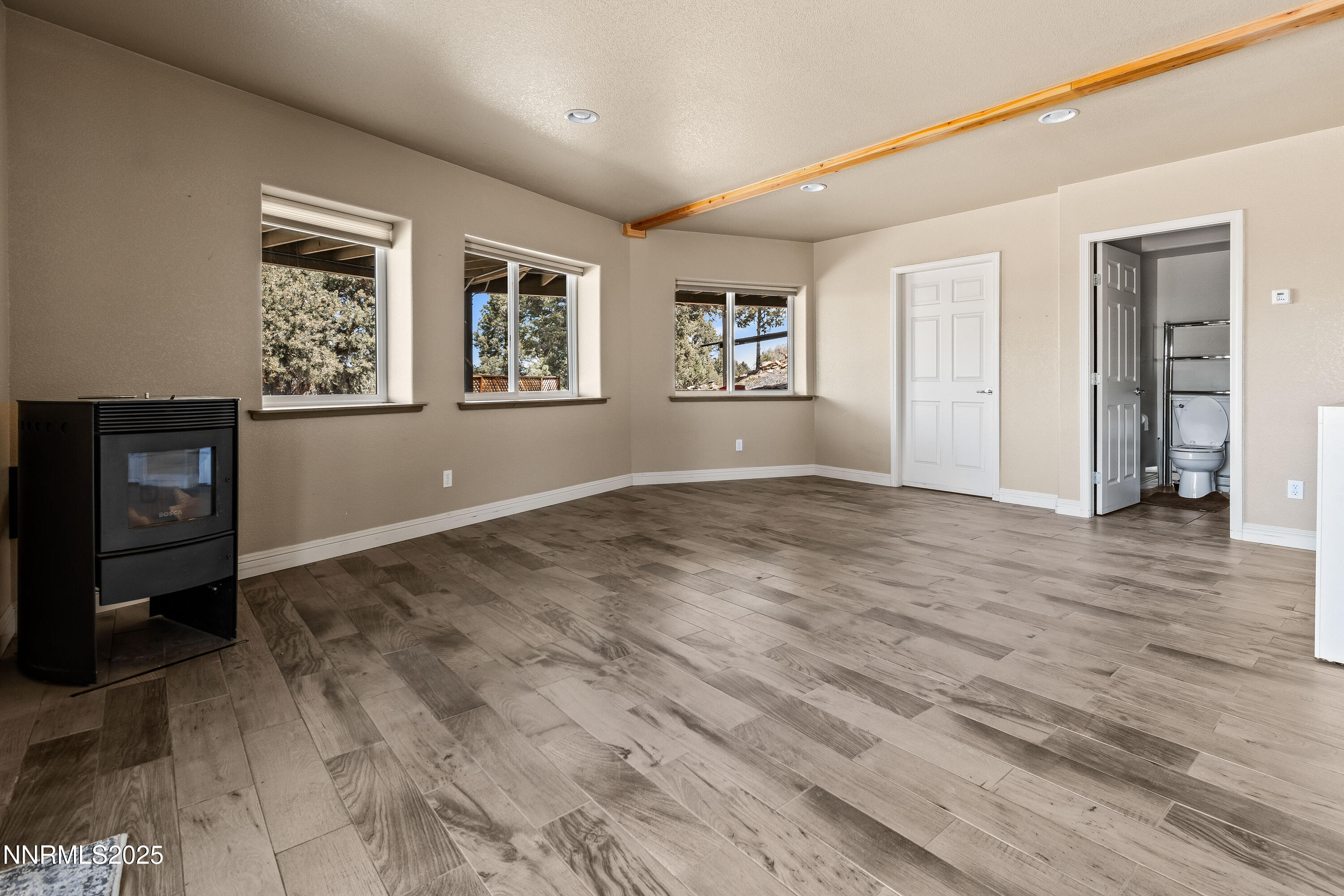 2140 Conestoga Road Reno, NV 89521 - Photo 24 of 35 a view of an empty room with window and wooden floor