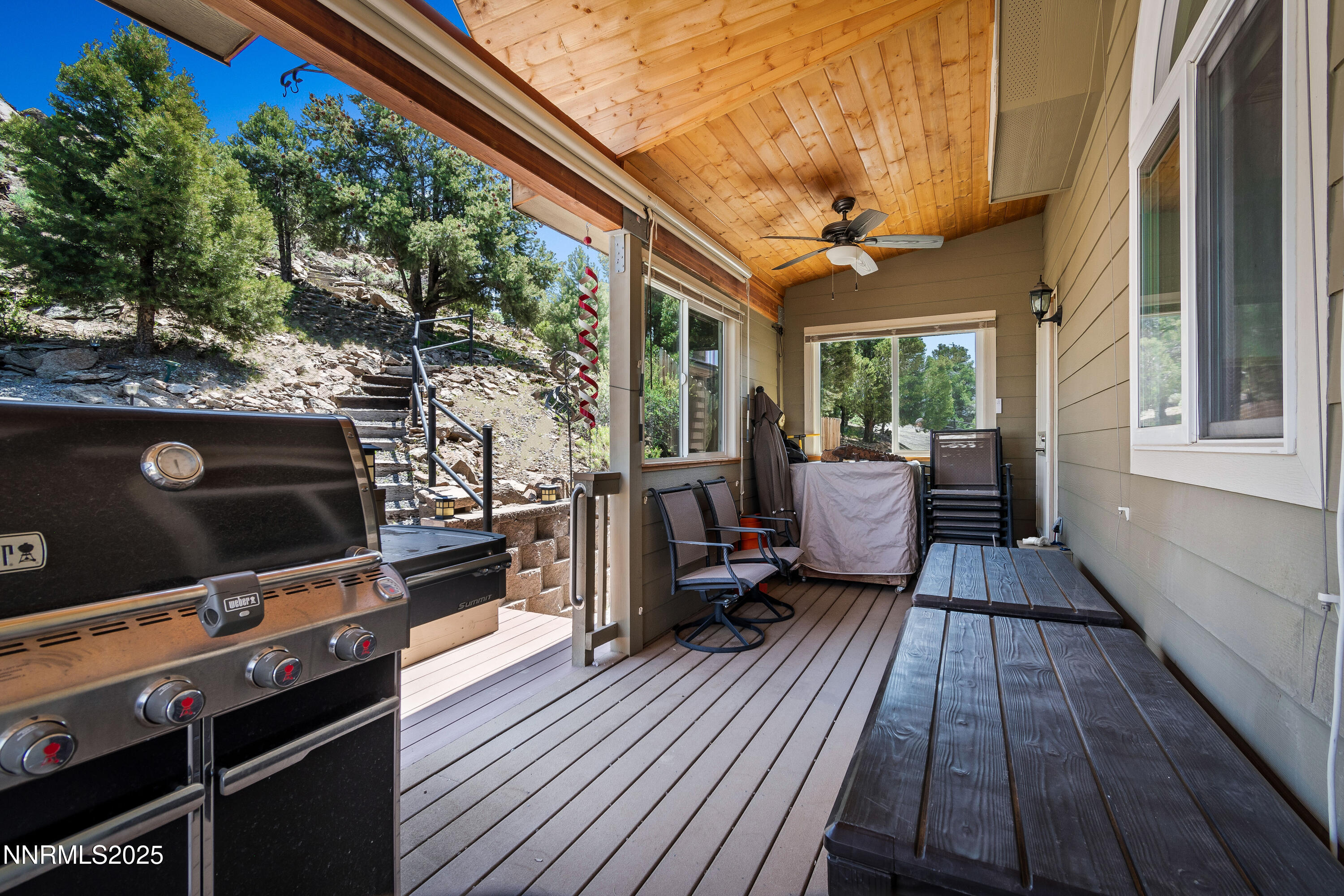 2140 Conestoga Road Reno, NV 89521 - Photo 29 of 35 a living room with patio fireplace and flat screen tv