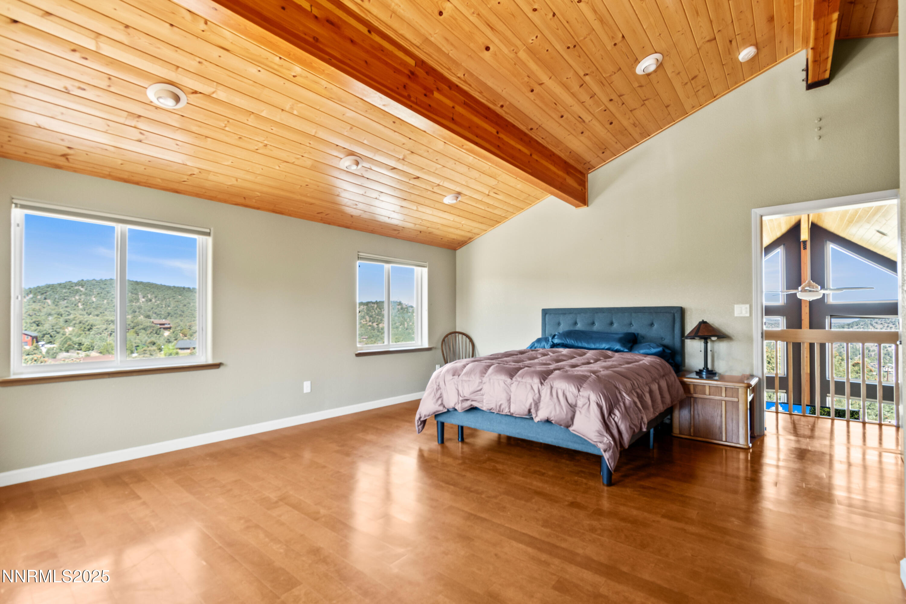 2140 Conestoga Road Reno, NV 89521 - Photo 10 of 35 a spacious bedroom with a bed and wooden floor