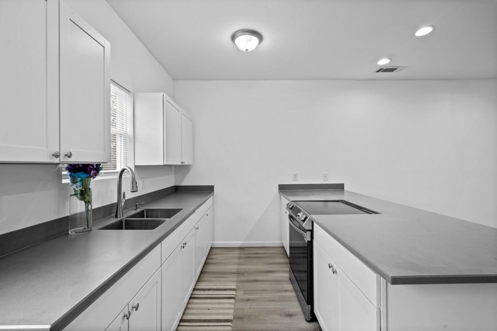 657 Summit Lane Ellijay, GA 30540 - Photo 11 of 33 a kitchen with granite countertop a sink and white cabinets