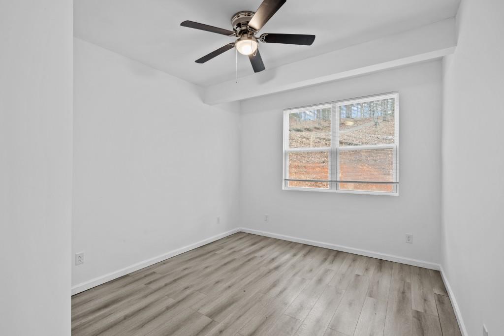 657 Summit Lane Ellijay, GA 30540 - Photo 26 of 33 a view of empty room with wooden floor and fan