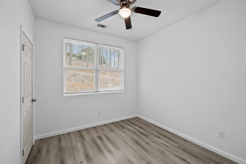 657 Summit Lane Ellijay, GA 30540 - Photo 28 of 33 a view of an empty room with wooden floor and a window