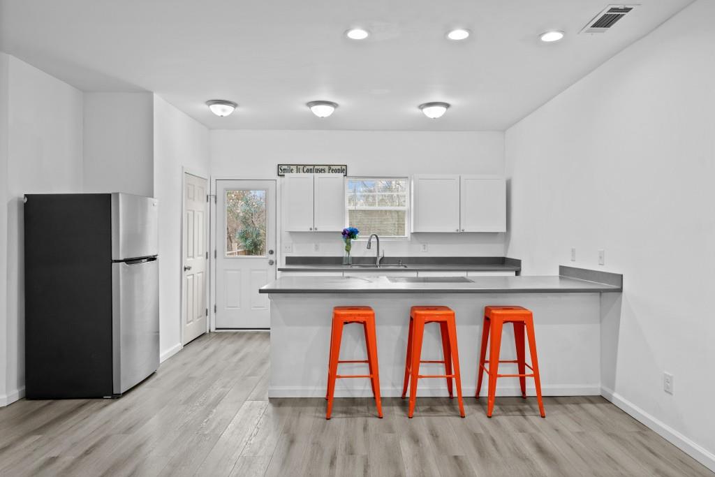657 Summit Lane Ellijay, GA 30540 - Photo 8 of 33 a kitchen with wooden floors and refrigerator