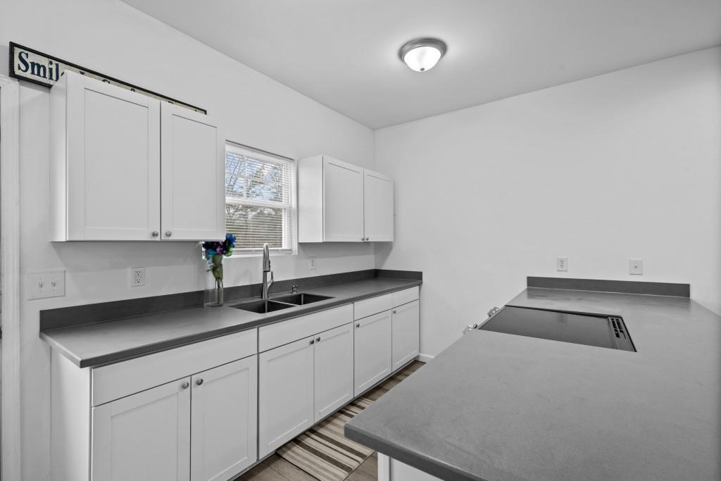 657 Summit Lane Ellijay, GA 30540 - Photo 10 of 33 a kitchen with granite countertop white cabinets and sink