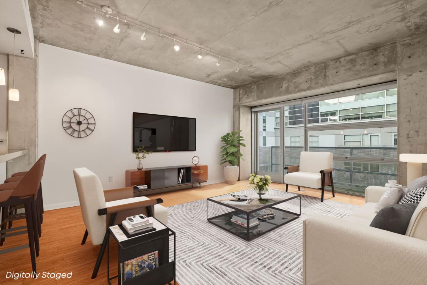 428 Alice Street, Unit 637 Oakland, CA 94607 - Photo 2 of 23 a living room with furniture a flat screen tv and a floor to ceiling window