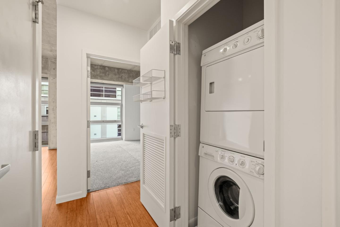 428 Alice Street, Unit 637 Oakland, CA 94607 - Photo 8 of 23 a view of a hallway with washer and dryer